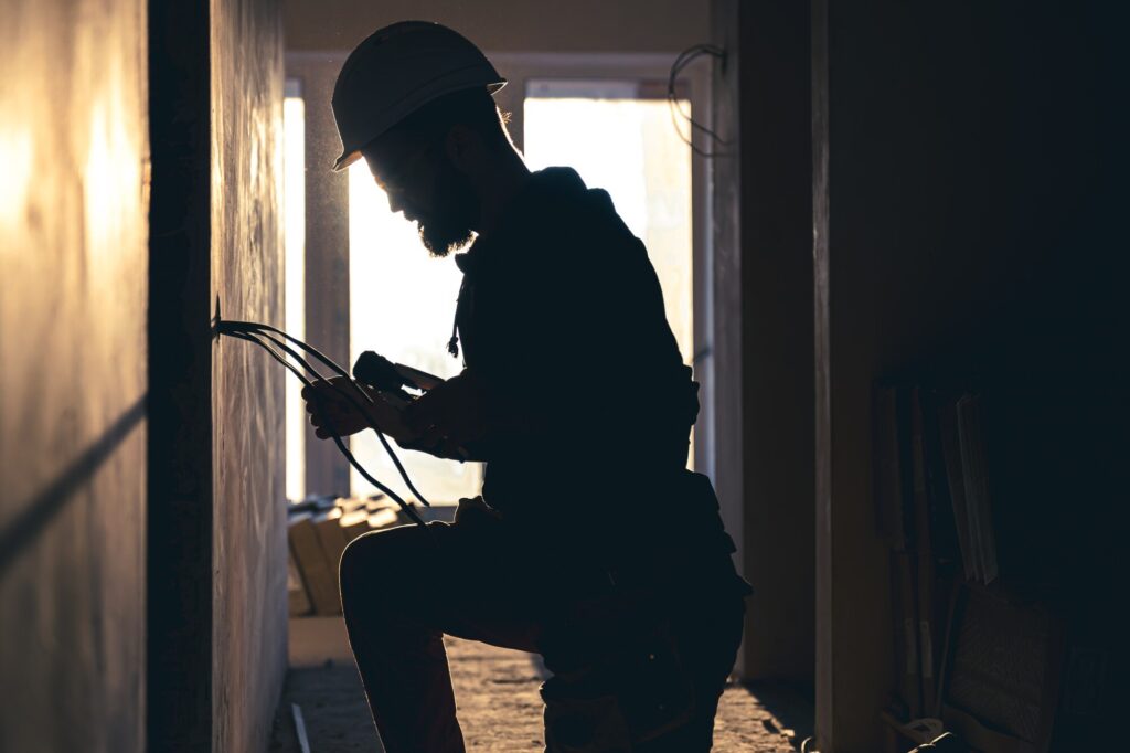 Electrical professional working on rewiring an irish house during a remodelling project