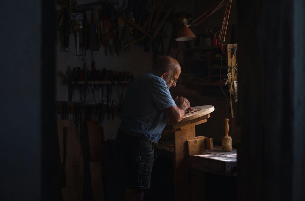 Old man carving wood