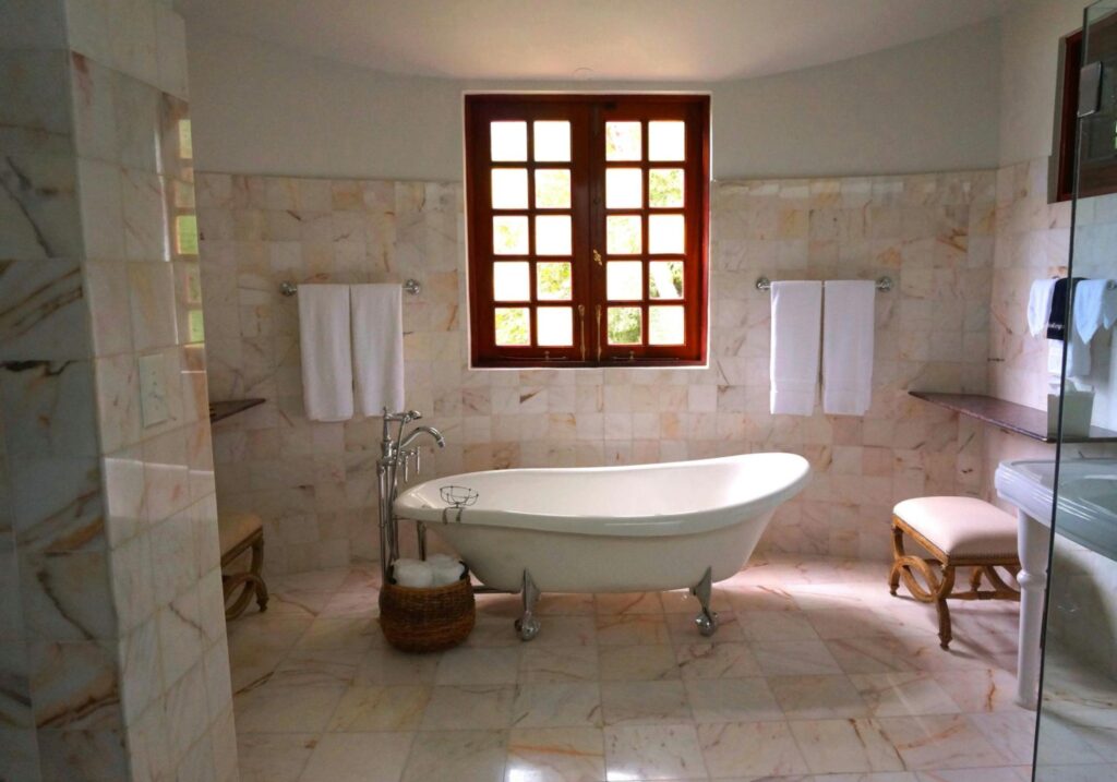 Modern bathroom with window and a bathtub.