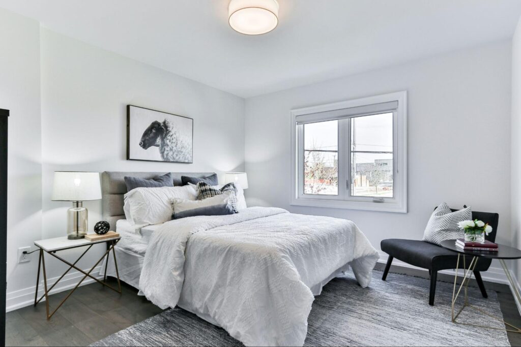 Minimalistic bedroom with a big bed in a monochromatic palette