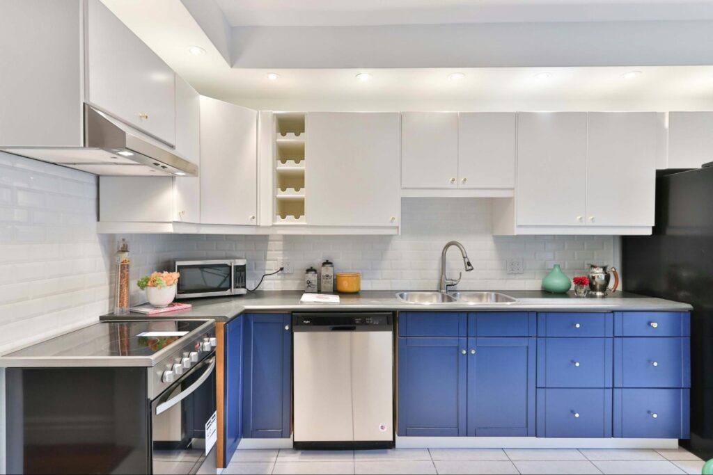 L-shaped kitchen design with blue cabinets and modern elements