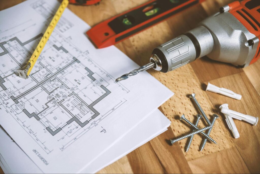 Schematics of a house and construction tools