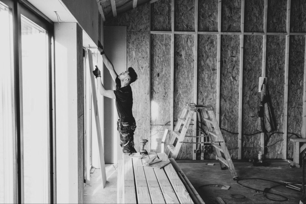 a renovation worker in ireland installing frames for plasterboard partition walls