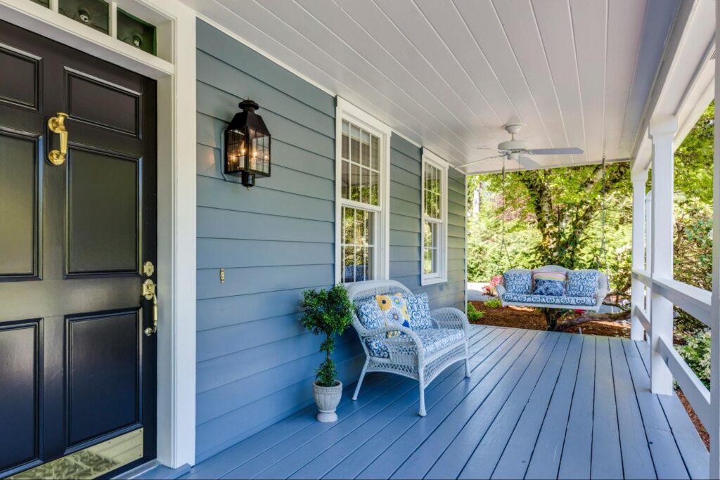 Blue porch with chairs and a swing