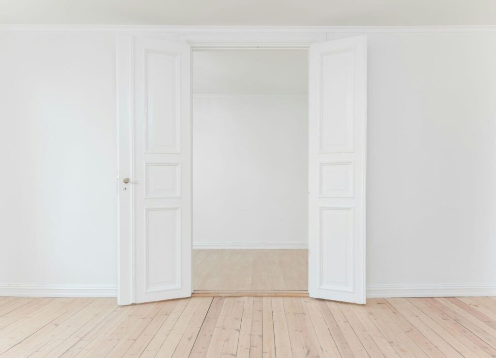 a white plasterboard separation wall with a door