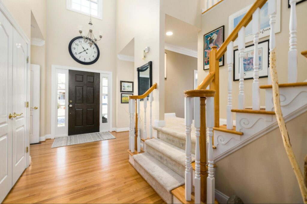 A modern home with a wooden staircase and door visible