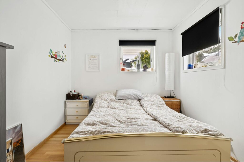A small bedroom with two windows