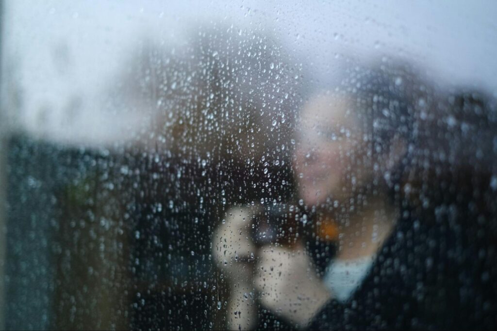 Woman standing behind a window