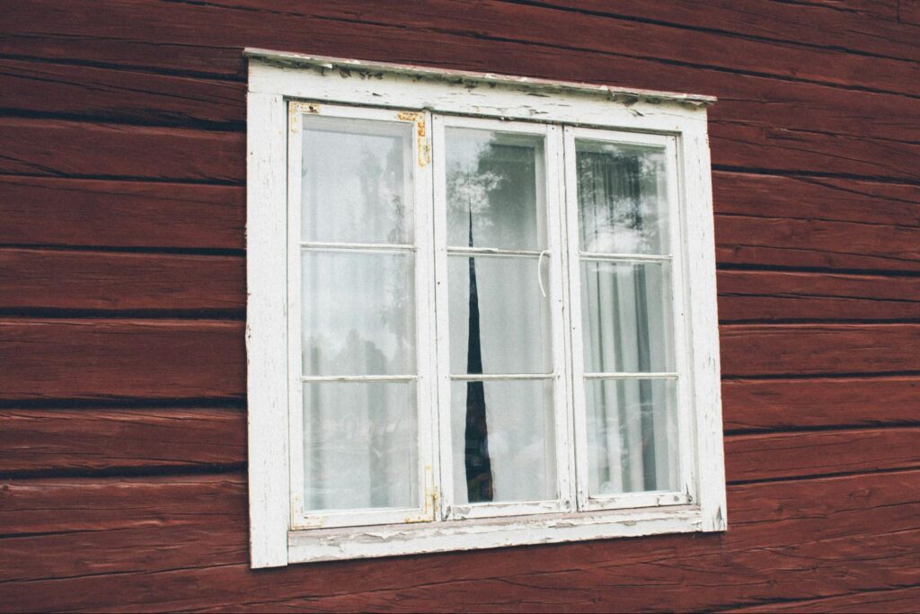 Old window on a red wall