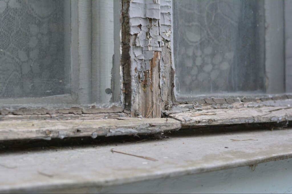 Old and worn window with peeling paint.
