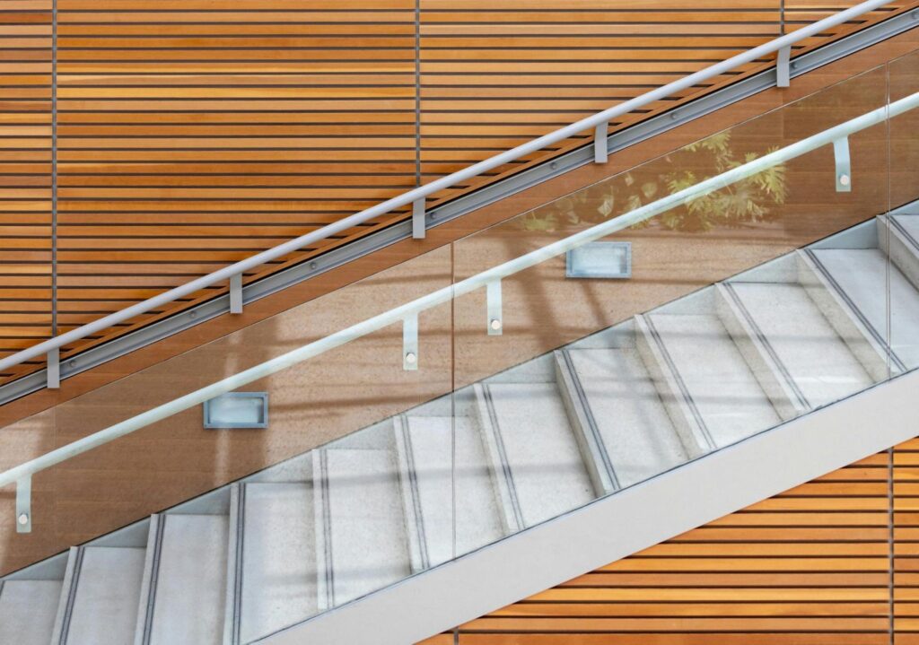 A modern glass staircase with wood panelling