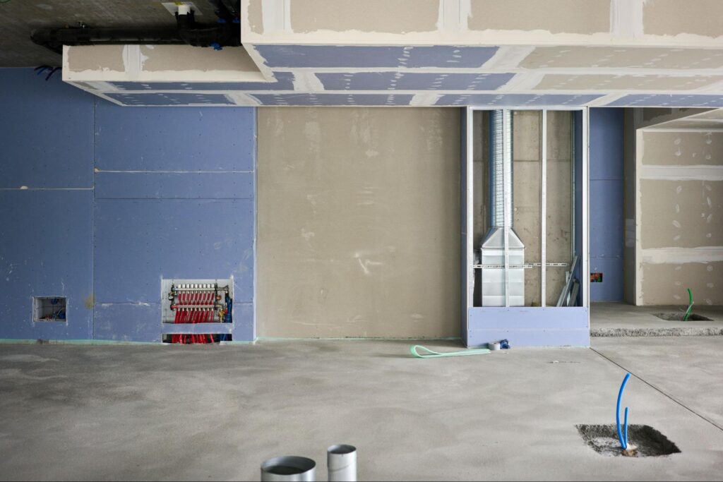 A big room during renovations with drywall installed