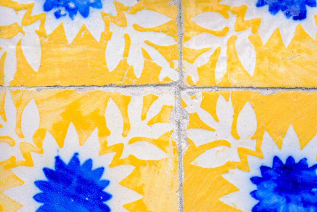 Painted bathroom tiles in blue and yellow